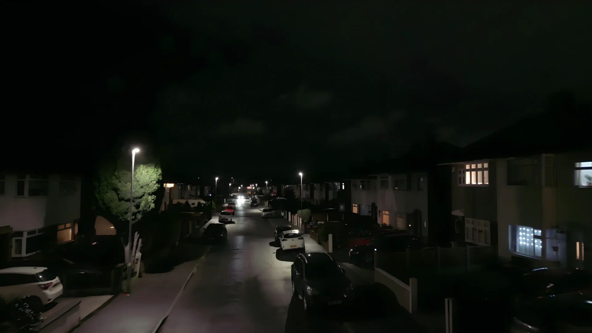INDO ION Road Direct Drive luminaires on a residential street at night.