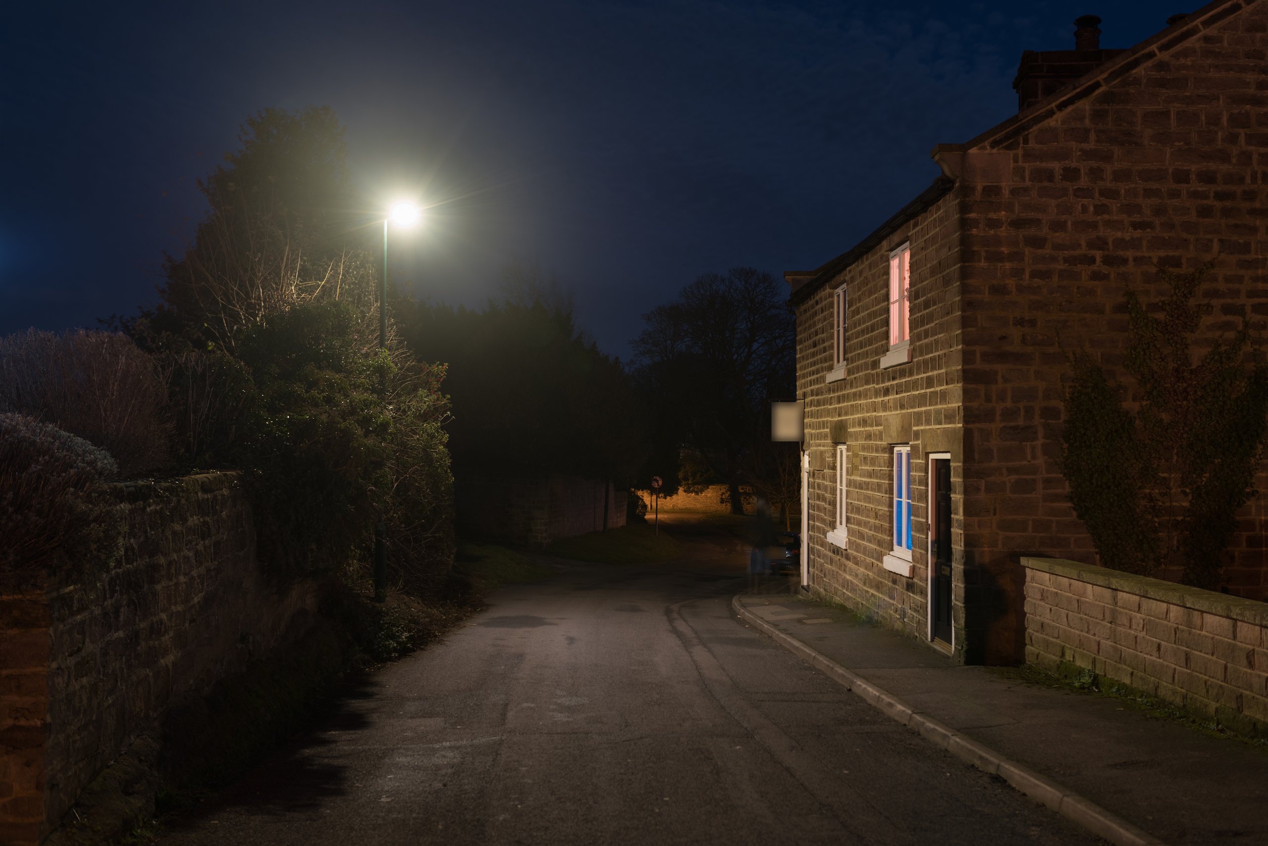 A stone-cottage lane in Spofforth at night, lit by an INDO SiCURA luminaire